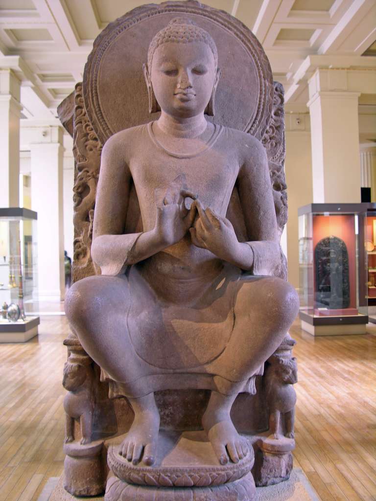 British Museum Top 20 Buddhism 03 Seated Buddha 3. Seated Buddha  Eastern India (possibly Sarnath), 5C AD, 1.18m high. This sandstone statue of Shakyamuni is notable for its posture, since it is more common to see him seated with legs crossed. Here he sits on a lion's throne with his feet on a double lotus. His hands are in the teaching mudra, delivering his first teaching in the Deer Park at Sarnath.